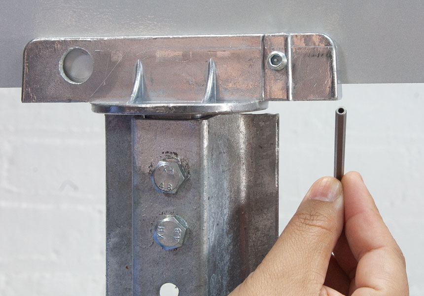 Step 2 of the installation of vandal resistant set screws on street name brackets